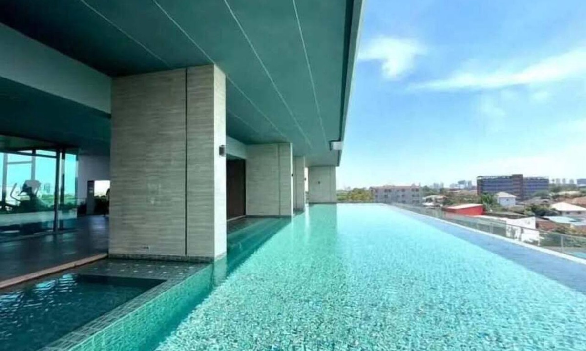 Nonthaburi Apartment | Modern 1-bedroom condo for up to 2 guests at Amber by Ester Star. Includes a separate bedroom, living area, kitchen, dining space, washing machine, balcony, city view and access to pool, gym, co-working space and shared building amenities.