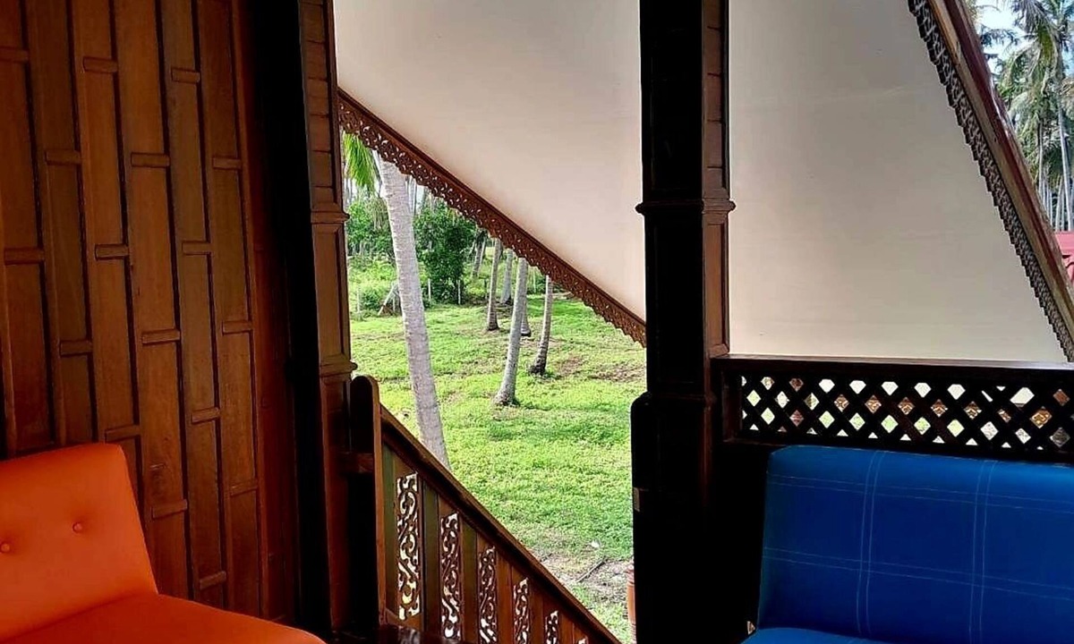 Thong Chai House | Traditional Thai wooden house on stilts set in a coconut orchard near the beach