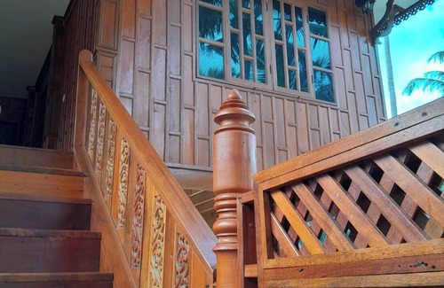 Thong Chai House | Traditional Thai wooden house on stilts set in a coconut orchard near the beach