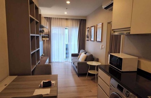 Nonthaburi Apartment | Modern 1-bedroom condo for up to 2 guests at Amber by Ester Star. Includes a separate bedroom, living area, kitchen, dining space, washing machine, balcony, city view and access to pool, gym, co-working space and shared building amenities.