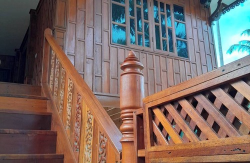 Thong Chai House | Traditional Thai wooden house on stilts set in a coconut orchard near the beach