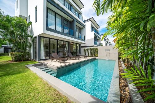 Modern minimalist style luxury villa with private pool located in a high-end resort area adjacent to Laguna Park Golf Course in Bang Tao Beach